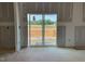 An unfinished living room featuring drywall for design, with sliding doors showcasing potential outdoor views at 15 Atherton Circle, Angier, NC 27501