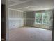Unfinished living room featuring two windows offering natural light and an open concept ready for customization at 15 Atherton Circle, Angier, NC 27501