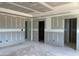 Unfinished living room featuring multiple doorways, providing connectivity to various rooms in an unfinished home at 15 Atherton Circle, Angier, NC 27501