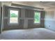 Unfinished living room featuring two windows offering natural light and an open concept ready for customization at 15 Atherton Circle, Angier, NC 27501