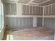An unfinished room with drywall and exposed floor awaiting customization with natural light from a window at 15 Atherton Circle, Angier, NC 27501