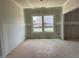Unfinished room with drywall awaiting personalization, featuring natural light through large double hung windows at 15 Atherton Circle, Angier, NC 27501
