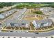 Aerial view of a neighborhood featuring grey and blue townhomes and well-manicured landscaping at 1613 Clayfire Dr, Cary, NC 27519