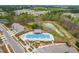 Aerial view featuring the neighborhood pool with seating, trees, and parking at 1613 Clayfire Dr, Cary, NC 27519