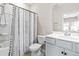 Bright bathroom featuring a shower-tub combo with a decorative curtain, a white sink and vanity at 1613 Clayfire Dr, Cary, NC 27519
