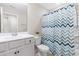 This bathroom features bright white vanity and fixtures, a modern shower curtain, and a bright overhead light at 1613 Clayfire Dr, Cary, NC 27519