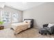 Bright bedroom featuring neutral carpet, a gray headboard, and natural light from two windows at 1613 Clayfire Dr, Cary, NC 27519
