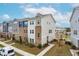 Modern townhome showcasing varied siding and brick accents in a well-maintained community with manicured landscaping at 1613 Clayfire Dr, Cary, NC 27519