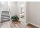 View of staircase with hardwood flooring and a bedroom seen through the doorway at 1613 Clayfire Dr, Cary, NC 27519