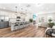 Bright, open-concept kitchen with white cabinets, stainless steel appliances, and a large island with bar seating at 1613 Clayfire Dr, Cary, NC 27519