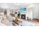 Open living area featuring a fireplace, hardwood floors, and seamless flow into the kitchen at 1613 Clayfire Dr, Cary, NC 27519