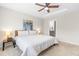 A spacious main bedroom features a tray ceiling, lots of light, neutral decor, and an ensuite bathroom at 1613 Clayfire Dr, Cary, NC 27519
