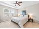 A spacious main bedroom features a tray ceiling, lots of light, and neutral decor with a ceiling fan at 1613 Clayfire Dr, Cary, NC 27519