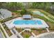 Aerial view of a community pool with a covered patio and surrounding landscaping at 1613 Clayfire Dr, Cary, NC 27519