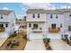 Rear view of townhomes, featuring private garages, balconies and driveways, set in a well-planned community at 1613 Clayfire Dr, Cary, NC 27519