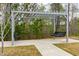 Outdoor seating area with a double swing under a pergola and concrete sidewalk at 1613 Clayfire Dr, Cary, NC 27519