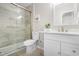 Clean, bright bathroom featuring a glass shower door, white vanity, and stylish fixtures at 200 Adefield Ln, Holly Springs, NC 27540