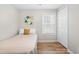 Neutral-toned bedroom with a single bed, wood-look flooring and a closet at 200 Adefield Ln, Holly Springs, NC 27540