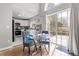 Cozy dining area with a glass table and chairs, adjacent to the kitchen and patio access at 200 Adefield Ln, Holly Springs, NC 27540