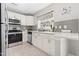 Well-lit kitchen with white cabinets, stainless steel appliances, and a window view at 200 Adefield Ln, Holly Springs, NC 27540