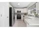 Efficient kitchen features white cabinets, stainless steel appliances, and ample counter space at 200 Adefield Ln, Holly Springs, NC 27540