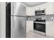 Kitchen featuring stainless steel appliances, white cabinets, and modern countertops at 200 Adefield Ln, Holly Springs, NC 27540