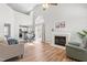 Bright living room boasts vaulted ceilings, a fireplace, hardwood floors, and an open floor plan at 200 Adefield Ln, Holly Springs, NC 27540
