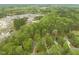 Aerial view of the neighborhood highlighting abundant trees and residential architecture at 2032 Stoneglen Ln, Raleigh, NC 27603