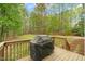 View of the backyard from the wooden back deck with grill at 2032 Stoneglen Ln, Raleigh, NC 27603