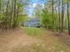 Spacious backyard featuring green grass and a tree-lined perimeter, adding privacy at 2032 Stoneglen Ln, Raleigh, NC 27603