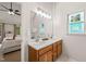 Bathroom vanity with double sinks, wood cabinets, and tiled floors at 2032 Stoneglen Ln, Raleigh, NC 27603