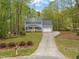 Charming two-story home with well-manicured landscaping and a bright yellow front door at 2032 Stoneglen Ln, Raleigh, NC 27603