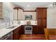 Well-lit kitchen features stainless steel appliances, wood cabinets, and quartz countertops at 2032 Stoneglen Ln, Raleigh, NC 27603