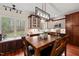 Charming eat-in kitchen boasts wood cabinets, a large window, and a rustic dining table at 2032 Stoneglen Ln, Raleigh, NC 27603