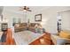 Comfortable living room with a large sectional sofa, hardwood floors, and access to outdoor area at 2032 Stoneglen Ln, Raleigh, NC 27603