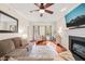 Bright living room with hardwood floors, fireplace, large windows, and comfortable seating at 2032 Stoneglen Ln, Raleigh, NC 27603