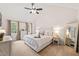 Bright main bedroom boasts neutral walls, ceiling fan, and a charming window at 2032 Stoneglen Ln, Raleigh, NC 27603