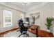 Home office with a tray ceiling, two large monitors, hardwood floors, and two large windows at 2032 Stoneglen Ln, Raleigh, NC 27603