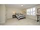 Bedroom with a blue plaid bedspread, neutral walls and carpet and shuttered windows at 208 Evanview Ct, Apex, NC 27523