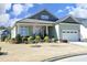 Charming one-story home with a metal roof, manicured lawn, and a welcoming front porch at 208 Evanview Ct, Apex, NC 27523