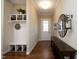 Inviting foyer with hardwood floors, decorative mirror, and a convenient mudroom bench at 208 Evanview Ct, Apex, NC 27523