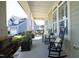 Inviting front porch with comfortable seating, stone accents, and views of the neighborhood at 208 Evanview Ct, Apex, NC 27523