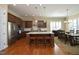 Spacious kitchen with stainless steel appliances, granite countertops, hardwood floors, and a cozy eat-in dining area at 208 Evanview Ct, Apex, NC 27523