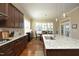 Open-concept kitchen with granite countertops, a large island, stainless steel appliances, and hardwood floors at 208 Evanview Ct, Apex, NC 27523