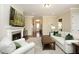Comfortable living room with a fireplace, hardwood floors, and inviting seating arrangement at 208 Evanview Ct, Apex, NC 27523