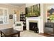 Bright living room featuring a fireplace, wine cooler, and comfortable seating area at 208 Evanview Ct, Apex, NC 27523