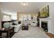 Spacious living room featuring a fireplace, neutral décor, and ample natural light at 208 Evanview Ct, Apex, NC 27523
