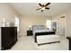 Comfortable main bedroom with neutral walls, plantation shutters, soft carpet, a ceiling fan, and a full ensuite bathroom at 208 Evanview Ct, Apex, NC 27523