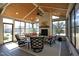 Cozy sunroom with a fireplace, vaulted wood ceiling, and abundant natural light at 208 Evanview Ct, Apex, NC 27523