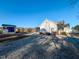 Wide shot of the backyard showing a well kept lawn, utility shed, patio, and swing set at 2105 Antioch Church Rd, Timberlake, NC 27583